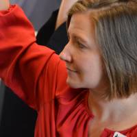 An alumna raising her hand